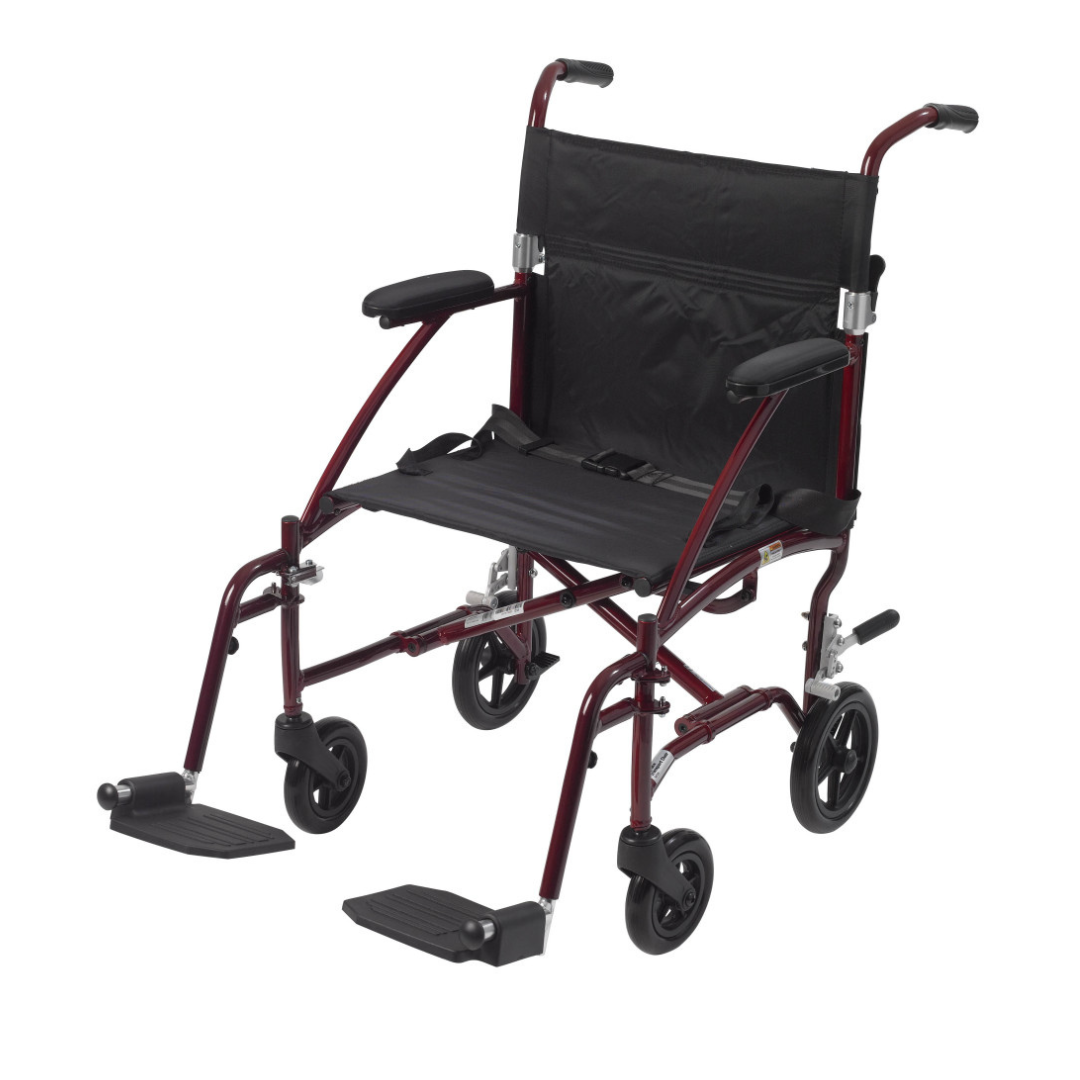 The Drive Fly-Lite Aluminum Transport Chair is foldable and lightweight, featuring a maroon frame, black seat and backrest, armrests, footrests, and four small wheels for easy portability.